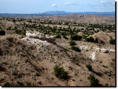 [Nambe Badlands white rim layer; Los Alamos in the background]