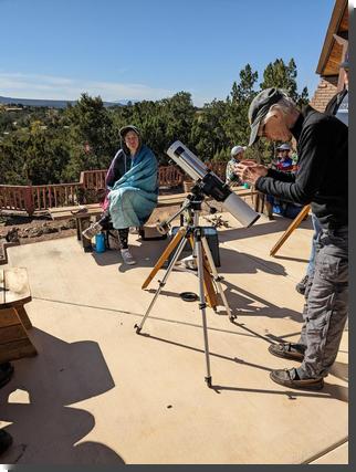 [person wrapped in blanket during annular eclipse]