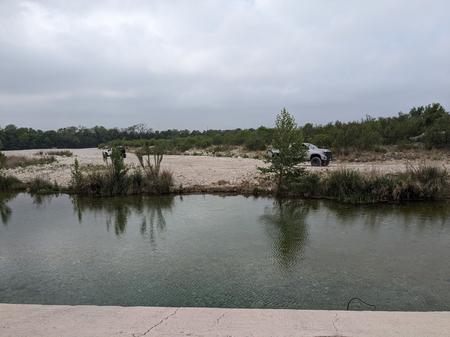 [people camped along the river at 19 Mile Crossing, TX]