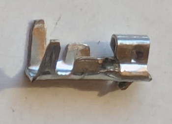 [a very small metal piece with several wings meant to be crimped]