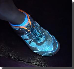 [a foot wearing a shoe and sock, fluorescing in interesting colors]