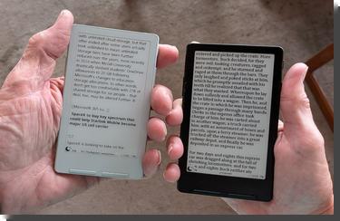 [Two Xteink X4 classics, tiny e-book readers, held in differently sized hands. One is white and held in a large hand, one black in a small hand]